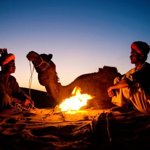 indian-men-resting-by-bonfire-with-their-camel (1)